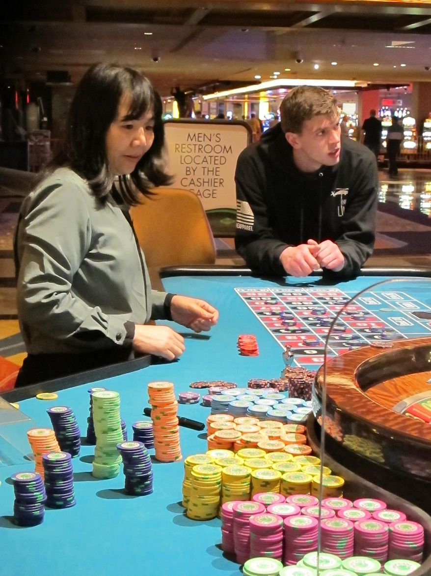 This April 17, 2015 photo shows a dealer at the Tropicana Casino and Resort in Atlantic City N.J. conducting a game of roulette. Nine years ago, the city's casinos started realizing they needed to offer more than just gambling if they still wanted visitors. Now, cash sales at non-gambling outlets within casinos represent 28.5 percent of revenue, up from 22.3 percent two years ago, and bars have increased their payrolls by nearly 39 percent in the past two years, according to a recent study conducted by the consulting firm Tourism Economics. (AP Photo/Wayne Parry)