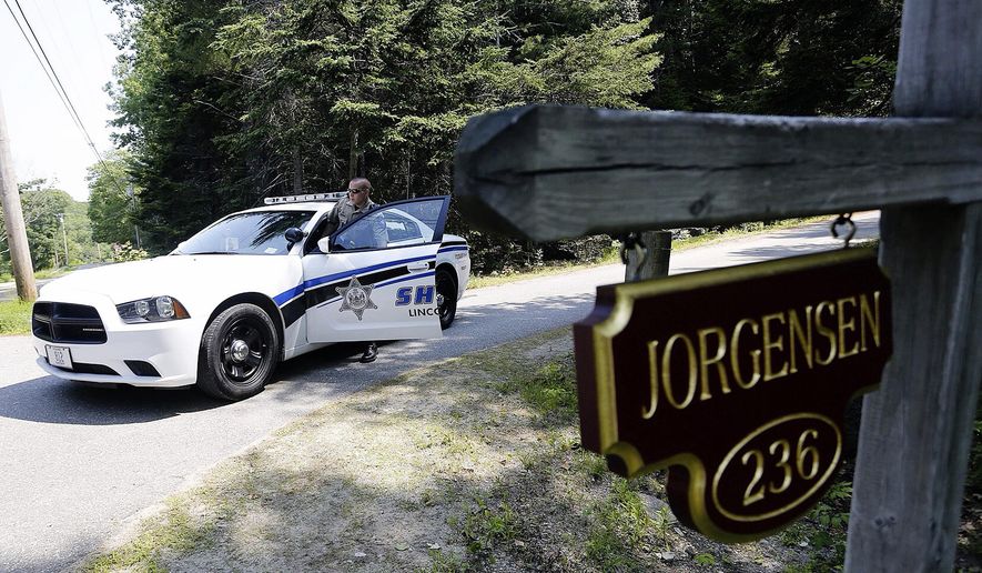 Lincoln County Deputy Ryan Chubbuck is stationed at the entrance to the Jorgensen residence on Lakeside Drive in Boothbay Harbor, Me., Sunday, July 5, 2015,following the discovery Saturday of three bodies at two residences in Boothbay Harbor. The bodies of Svend Jorgensen, 71, and his wife, Carol Jorgensen, 75, were discovered Saturday in their home on Lakeside Drive in Boothbay Harbor, Me. The body of their son, Eric Jorgensen, was found at his Montgomery Road home. (Derek Davis/Portland Press Herald via AP)