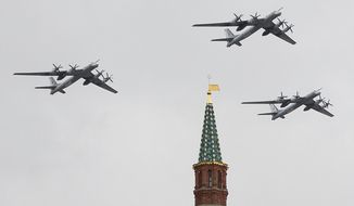 Russian Air Force strategic bombers fly in formation over Red Square on May 7, 2014, during a rehearsal for the Victory Day military parade two days later in Moscow. (Associated Press)
