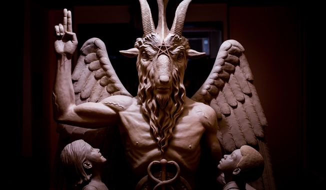 This 2014 photo provided by The Satanic Temple shows a bronze Baphomet, which depicts Satan as a goat-headed figure surrounded by two children. (The Satanic Temple via AP) ** FILE **