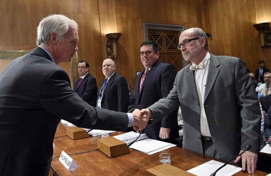 Senate Homeland Security and Governmental Affairs Committee Chairman, Sen. Ron Johnson, R-Wis., left, shakes hands with Associate Director of Refuee, Asylum, and International Operations at U.S. Citizenship and Immigration Services at the Department of Homeland Security, Joseph E. Langlois, right, before the start of a hearing on Capitol Hill in Washington, Tuesday, July 7, 2015, on children coming across the border and deportations. The additional witnesses, from left, are Director of the Executive Office of Immigration Review at the Department of Justice, Juan P. Osuna, Acting Assistant Secretary of Administration for Children and Families at the Department of Health and Human Services, Mark H. Greenberg and Assistant Director of Field Operations, Enforcement and Removal Operations at the U.S. Immigration and Customs Enforcement at the Department of Homeland Security, Philip T. Miller. (AP Photo/Susan Walsh)