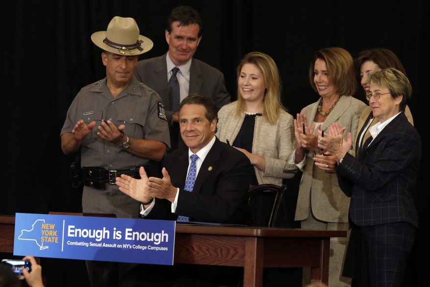 New York Gov. Andrew Cuomo, center is joined by U.S. House Minority Leader Nancy Pelosi, third from right, Abigail Gatewood, third from left, after signing a bill during a ceremony at New York University, Tuesday, July 7, 2015. Cuomo signed a bill into law Tuesday that requires New York state's private colleges and universities to have a new, affirmative sexual consent policy to combat campus sexual violence. (AP Photo/Mary Altaffer) **FILE**