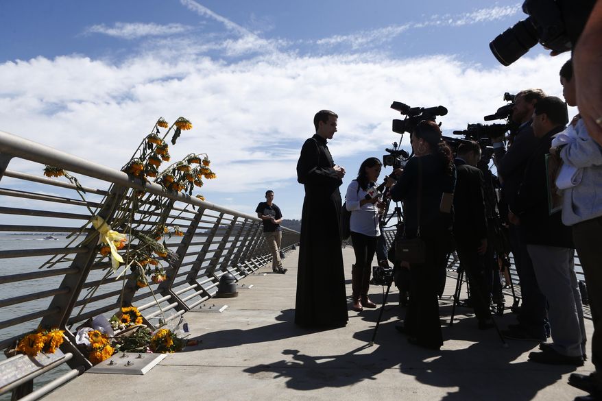 Father Cameron Faller, of Restorative Justice Ministry, answers questions before a vigil for Kathryn Steinle, Monday, July 6, 2015, on Pier 14 in San Francisco. Steinle was shot and killed on Wednesday, July 1st on Pier 14. Francisco Sanchez was arrested for the shooting. (AP Photo/Beck Diefenbach)