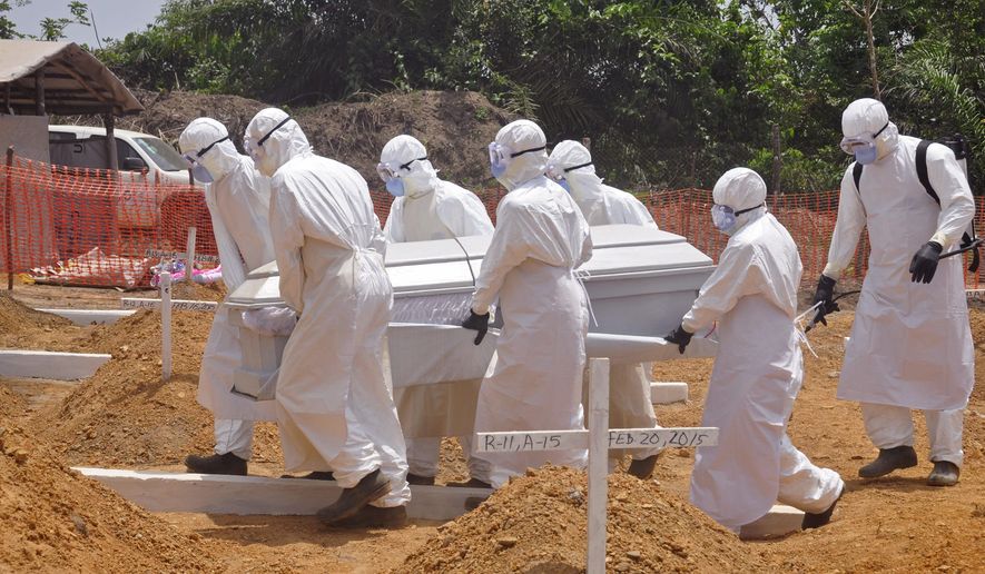 FILE - In this Wednesday, March 11, 2015 file photo, health workers carry a body of a person that they suspected died form the Ebola virus at a new graveyard on the outskirts of Monrovia, Liberia. A panel commissioned by the World Health Organization to assess its bungled response to the world’s biggest Ebola outbreak said the crisis exposed the agency’s “organizational failings” and called for WHO to be held accountable. But the report failed to identify any individuals responsible for the failures, instead blaming WHO’s bureaucratic culture. In its final report issued on Tuesday, July 7, 2015 the panel said WHO’s sluggish efforts to contain Ebola were partly explained by “a hope that the crisis could be managed by good diplomacy.” (AP Photo/ Abbas Dulleh,File)