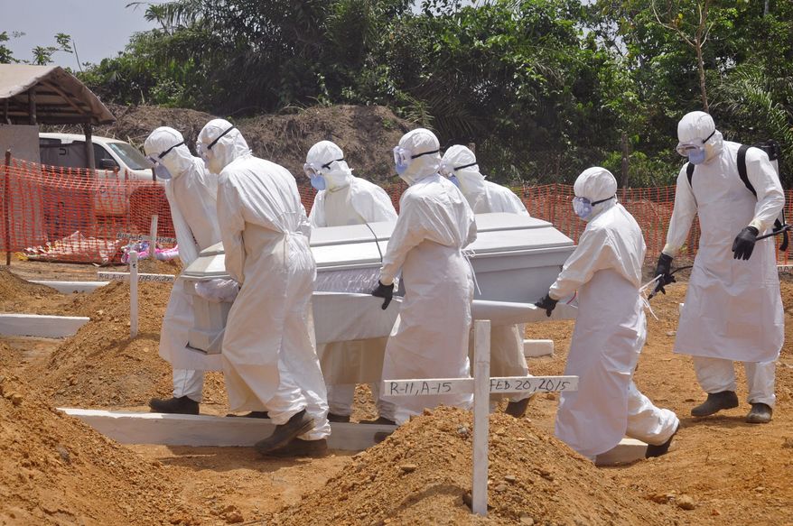 FILE - In this Wednesday, March 11, 2015 file photo, health workers carry a body of a person that they suspected died form the Ebola virus at a new graveyard on the outskirts of Monrovia, Liberia. A panel commissioned by the World Health Organization to assess its bungled response to the world’s biggest Ebola outbreak said the crisis exposed the agency’s “organizational failings” and called for WHO to be held accountable. But the report failed to identify any individuals responsible for the failures, instead blaming WHO’s bureaucratic culture. In its final report issued on Tuesday, July 7, 2015 the panel said WHO’s sluggish efforts to contain Ebola were partly explained by “a hope that the crisis could be managed by good diplomacy.” (AP Photo/ Abbas Dulleh,File)