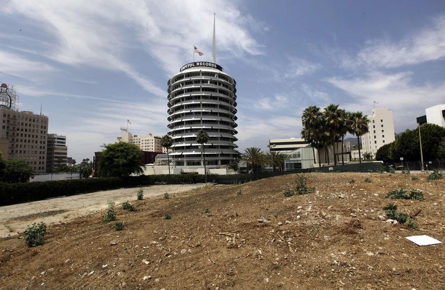 FILE - This Friday, Aug. 3, 2013 file photo shows the Capitol Records building beyond the site of the Millennium Hollywood development in the Hollywood district of Los Angeles. Los Angeles building officials on Monday, July 6, 2015 approved plans to build the 1 million-square-foot complex of skyscrapers, stores and restaurants on the lot, agreeing with the developer that an earthquake fault underneath the property is too old to be considered active. (AP Photo/Reed Saxon, File)