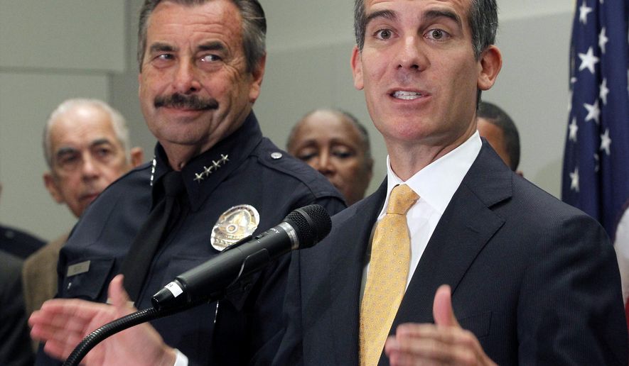 Los Angeles Mayor Eric Garcetti, right, speaks as Police Chief Charlie Beck listens at left at a news conference to discuss mid year crime statistics in Los Angeles Wednesday, July 8, 2015. Crime has increased 13 percent in Los Angeles in the first six months of the year, ending more than a decade of declines in the nation’s second-largest city, according to statistics released by the Los Angeles Police Department on Wednesday. Garcetti said “this is bad news” but that Los Angeles remains one of the safest large cities in the U.S. Beck partially attributed the crime spike to increases in homelessness, gang crime and domestic violence.(AP Photo/Nick Ut)