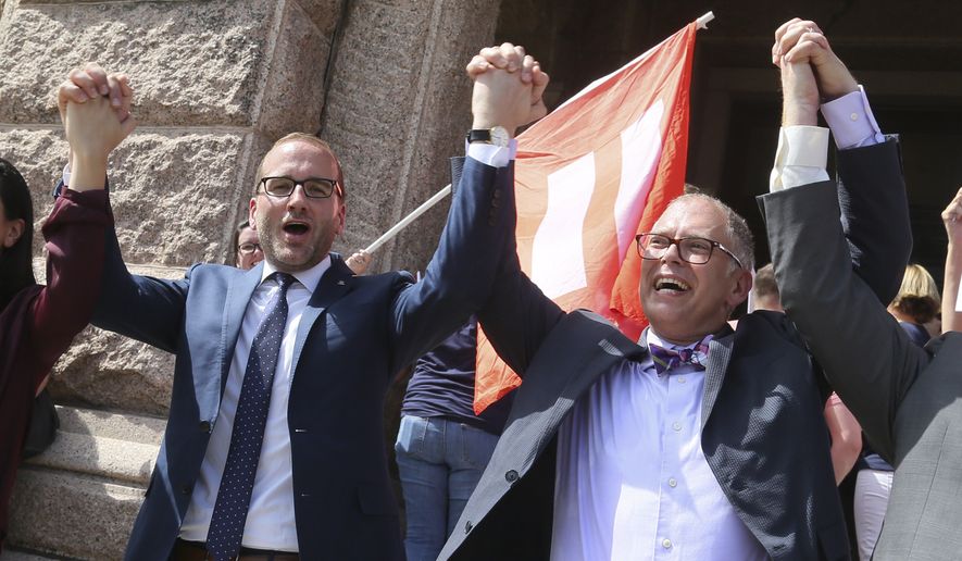 Human Rights Campaign president Chad Griffin. left, and Jim Obergefell, named plaintiff in the historic U.S. Supreme Court same-sex marriage case, cheer during a press conference held at the Texas Capitol to discuss the local effect of the marriage equality ruling on Monday, June 29, 2015 in Austin, Texas. (Jack Plunkett/AP Images for Human Rights Campaign)