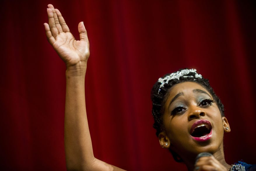 ADVANCE FOR THE WEEKEND OF JULY 11-12 AND THEREAFTER - In this photo taken on June 5, 2015, Ramya Hall-Johnson, 11, of Swartz Creek, practices for an upcoming performance at Swartz Creek Performing Arts Center in, Swartz Creek, Mich. The rising singing star, has already performed at the heralded Apollo Theater in New York City, as well as performances throughout Genesee County and across the country. (Jake May/The Flint Journal-MLive.com via AP) LOCAL TELEVISION OUT; LOCAL INTERNET OUT; MANDATORY CREDIT
