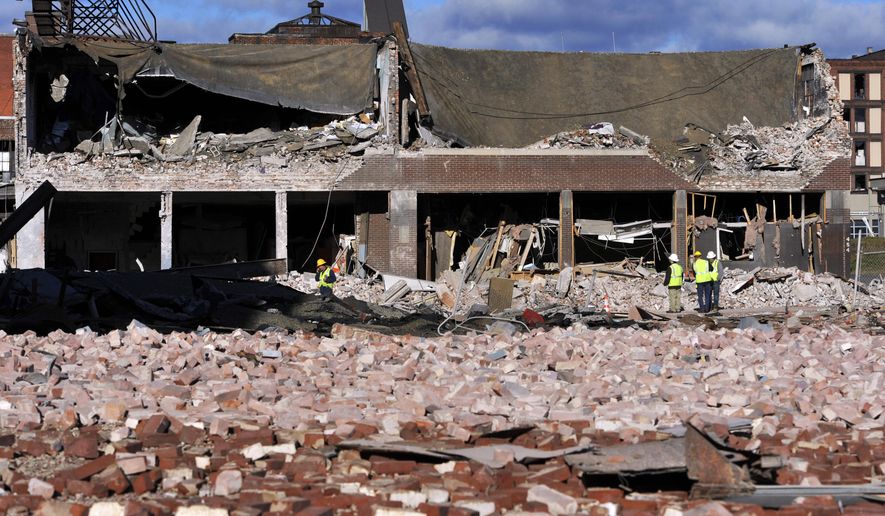 FILE - In this Nov. 24, 2012 file photo, inspectors assess damage around the area of a gas explosion that leveled a strip club in Springfield, Mass. on Nov. 23. The Obama administration moved Wednesday, July 8, 2015 to significantly expand a requirement for utilities to install inexpensive safety valves on natural gas lines across the U.S. to reduce the risk of deadly explosions. An Associated Press investigation in 2012 uncovered more than 270 accidents dating to 1968 that could have been prevented or made less dangerous if the valves had been in place, including the 2012 Springfield blast.(AP Photo/Jessica Hill, File)