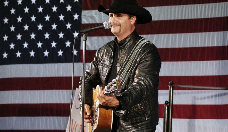FILE - In this Nov. 2, 2009 file photo, John Rich of the musical group, Big &amp;amp; Rich, performs at a rally for 23rd Congressional District candidate, Doug Hoffman, in Watertown, N.Y. Mainstream country music has been quietly distancing itself from the Confederate flag for years, but as the debate reignites following a massacre at a black church in South Carolina on June 17, country artists still struggle to articulate their feelings about the flag’s history and symbolism. Rich told Fox News’ Sean Hannity that he agreed with South Carolina Gov. Nikki Haley’s call to remove the Confederate flag from the state capitol. (AP Photo/Heather Ainsworth, File)