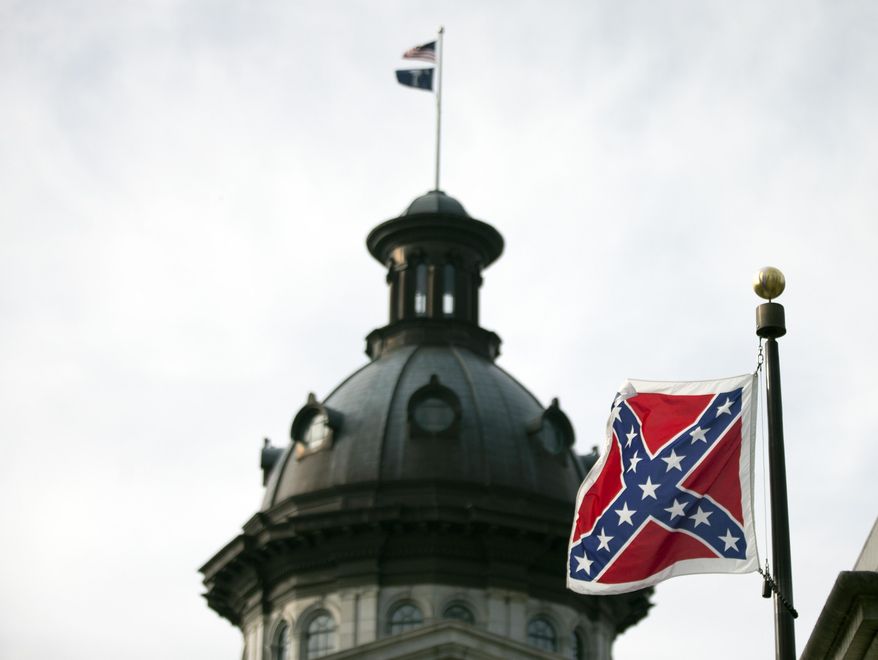 A Confederate battle flag flies in front of the South Carolina statehouse Wednesday, July 8, 2015, in Columbia, S.C. The House is expected to debate a measure Wednesday that would remove the flag from the Capitol grounds. (AP Photo/John Bazemore)