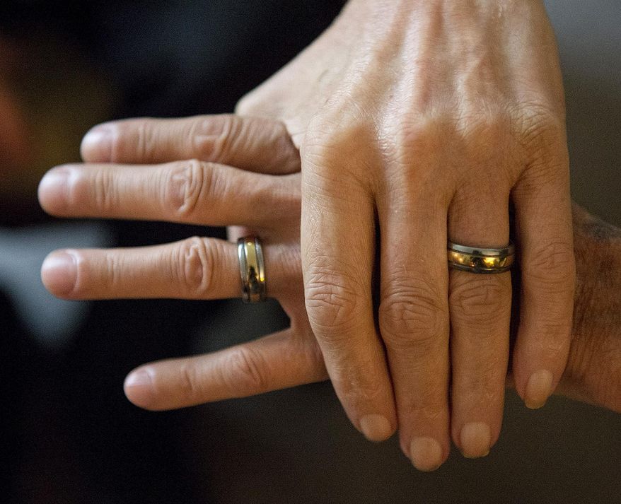 ADVANCE FOR USE SUNDAY, JULY 12 AND THEREAFTER - In this May 27, 2015 photo, Eddie Salter and Michael Smith show off their titanium and gold wedding rings at home in Carbondale, Ill. The two have been together for nearly 50 years. (Byron Hetzler/The Southern via AP)
