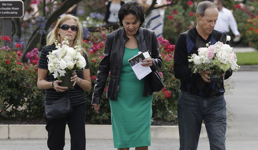 Two women and a man walk toward the parking lot after a memorial service for Kathryn Steinle in Pleasanton, Calif., Thursday, July 9, 2015. Steinle, of San Francisco, was gunned down by Juan Francisco Lopez Sanchez on July 1 while walking along a city pier with her father. (AP Photo/Jeff Chiu)