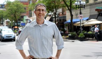 In this photo taken on Wednesday, Aug. 6, 2014, Ann Arbor, Mich., Mayor Christopher Taylor, poses for a photograph in downtown Ann Arbor. (Melanie Maxwell/The Ann Arbor News via AP) ** FILE **