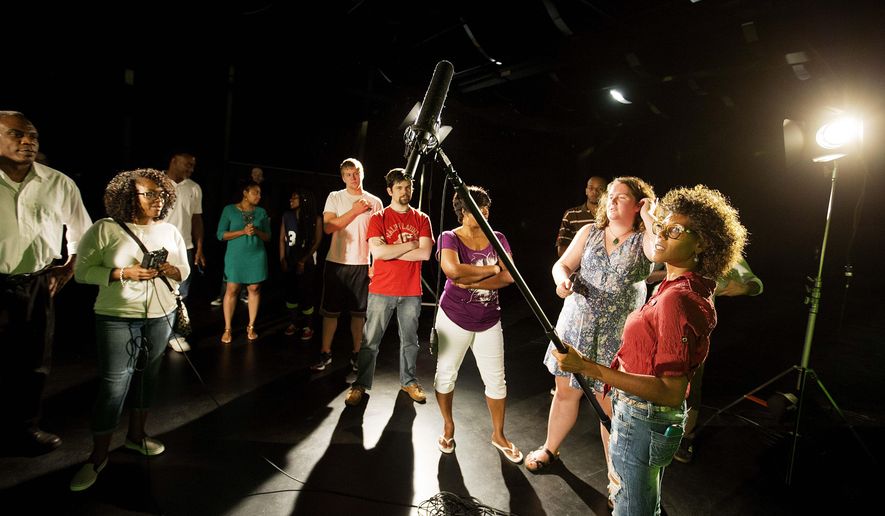 In this Tuesday, July 7, 2015 photo, student Sherelle Briers, of Stockbridge, Ga., holds a boom microphone during a digital film technician program introductory class at Clayton State University in Jonesboro, Ga. Last July, representatives for top film and television producers including NBC and Marvel warned state officials that finding trained crew members is a struggle. Several of the state’s technical schools and universities immediately began developing programs. (AP Photo/David Goldman)