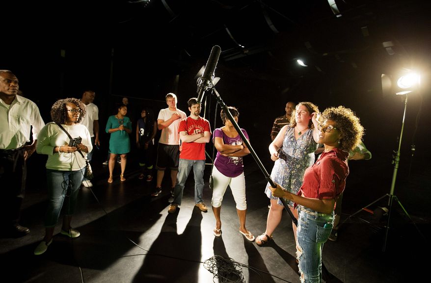In this Tuesday, July 7, 2015 photo, student Sherelle Briers, of Stockbridge, Ga., holds a boom microphone during a digital film technician program introductory class at Clayton State University in Jonesboro, Ga. Last July, representatives for top film and television producers including NBC and Marvel warned state officials that finding trained crew members is a struggle. Several of the state’s technical schools and universities immediately began developing programs. (AP Photo/David Goldman)