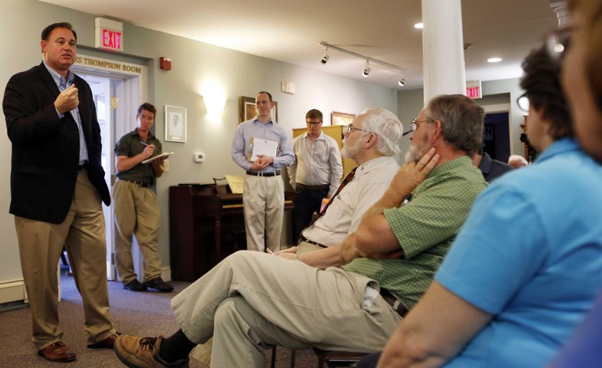 U.S. Rep. Frank Guinta, left, speaks, Saturday, July 11, 2015, in Alton, N.H., during his first town hall meeting since the Federal Election Commission concluded that he took $355,000 in illegal campaign donations from his parents. (AP Photo/Jim Cole)