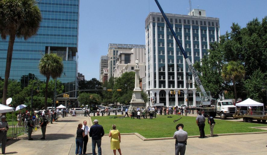 File-This July 10, 2015, file photo shows workers pulling down the pole where the Confederate flag flew for 15 years at the South Carolina Statehouse in Columbia, S.C. The NAACP has passed a resolution lifting its 15-year economic boycott of South Carolina, a day after that state took down a Confederate battle flag flying near its Statehouse. The civil rights group approved the measure Saturday, July 11, 2015, at its national convention in Philadelphia to end the boycott of tourism and other economic activity. (AP Photo/Jeffrey Collins, File)