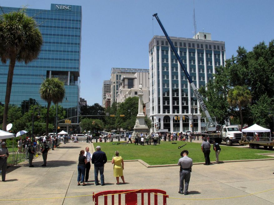 File-This July 10, 2015, file photo shows workers pulling down the pole where the Confederate flag flew for 15 years at the South Carolina Statehouse in Columbia, S.C. The NAACP has passed a resolution lifting its 15-year economic boycott of South Carolina, a day after that state took down a Confederate battle flag flying near its Statehouse. The civil rights group approved the measure Saturday, July 11, 2015, at its national convention in Philadelphia to end the boycott of tourism and other economic activity. (AP Photo/Jeffrey Collins, File)