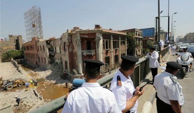 Egyptian police officers stand on the 6th October bridge opposite the Italian consulate following a blast in Cairo, Egypt, Saturday, July 11, 2015. A large explosion struck outside the Italian Consulate in Egypt&#x27;s capital Cairo early Saturday, severely damaging the building and killing one civilian, and injuring four others, officials said. An Italian diplomat said the consulate was closed at the time and no staff members were wounded in the blast. (AP Photo/Amr Nabil) ** FILE **