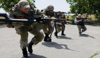 In this photo taken on Thursday, June  25, 2015, members of a self-defense unit carry out exercise drills in a location outside Odessa, Ukraine. Odessa lies more than 500 kilometers (300 miles) west of the front line in east Ukraine, where government troops are mired in a war of attrition against Russian-backed separatists. (AP Photo/Sergei Chuzavkov)