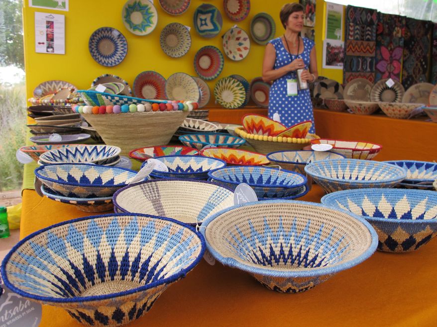 In this photo taken Saturday, July 11, 2015, works of Tintsaba master basket weavers from Swaziland are displayed at the 12th annual International Folk Art Market in Santa Fe, N.M. The market draws close to 20,000 people and dozens of artists from around the globe over three days. (AP Photo/Susan Montoya Bryan)
