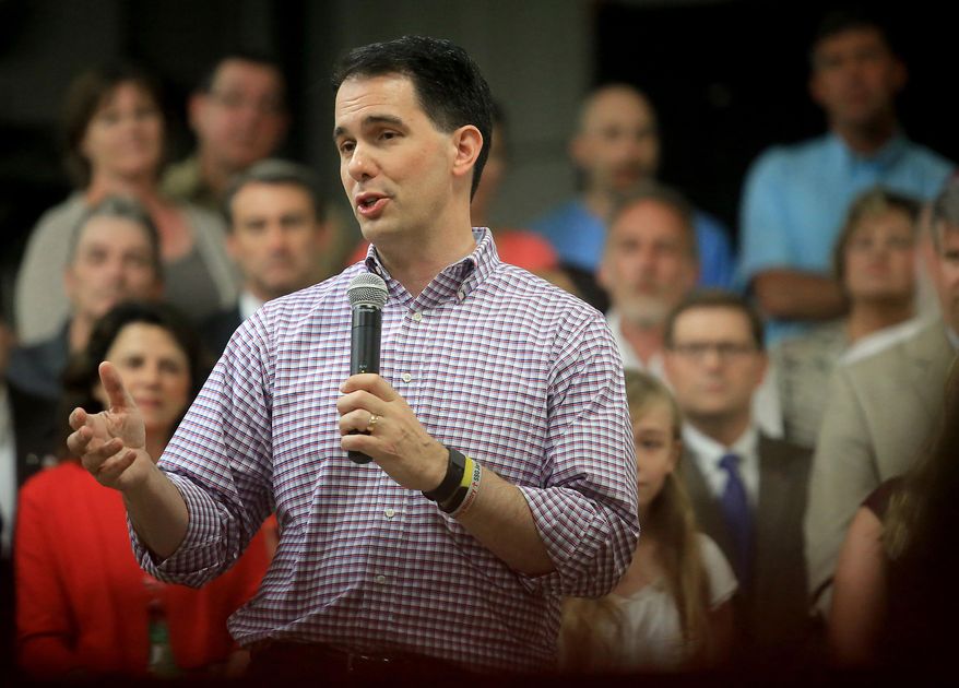 Wisconsin Gov. Scott Walker addresses employees and members of the media at Valveworks USA prior to signing the state&#39;s 2015-2017 budget on the production floor of the Waukesha, Wis. company Sunday, July 12, 2015. (John Hart/Wisconsin State Journal via AP)