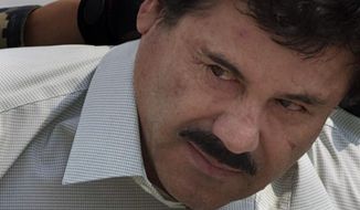 Joaquin &quot;El Chapo&quot; Guzman is escorted to a helicopter in handcuffs by Mexican navy marines at a navy hanger in Mexico City, Feb. 22, 2014. (AP Photo/Eduardo Verdugo, file) ** FILE **