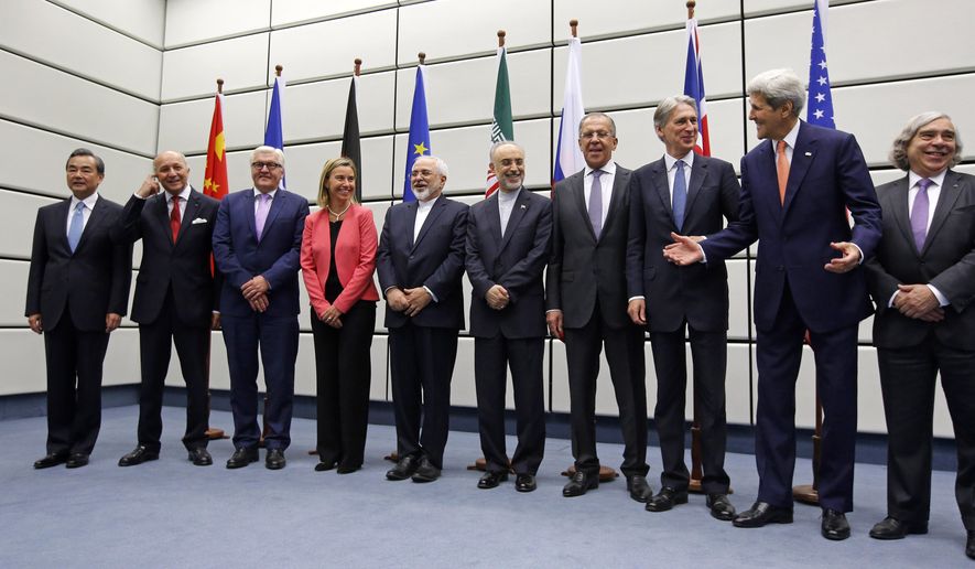 From left to right,  Chinese Foreign Minister Wang Yi, French Foreign Minister Laurent Fabius, German Foreign Minister Frank Walter Steinmeier, European Union High Representative for Foreign Affairs and Security Policy Federica Mogherini, Iranian Foreign Minister Mohammad Javad Zarif, Head of the Iranian Atomic Energy Organization Ali Akbar Salehi, Russian Foreign Minister Sergey Lavrov, British Foreign Secretary Philip Hammon, U.S. Secretary of State John Kerry and U.S. Secretary of Energy Ernest Moniz pose for a group picture at the United Nations building in Vienna, Austria, Tuesday, July 14, 2015.  After 18 days of intense and often fractious negotiation, world powers and Iran struck a landmark deal Tuesday to curb Iran&#39;s nuclear program in exchange for billions of dollars in relief from international sanctions ó an agreement designed to avert the threat of a nuclear-armed Iran and another U.S. military intervention in the Muslim world. (Carlos Barria, Pool Photo via AP)