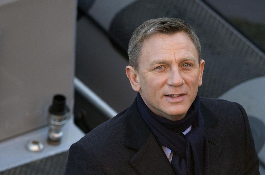 FILE - In this Tuesday, Dec. 16, 2014 file photo, actor Daniel Craig smiles for photographers as he films a scene for the new James Bond film, Spectre, in London. Stars including Daniel Craig and Judi Dench are urging the British government and signed the Wednesday July 15, 2015 letter to Prime Minister David Cameron to protect the BBC, as the publicly funded broadcaster faces budget cuts and political pressure for its ambitions to be curbed. (AP Photo/Alastair Grant, File)
