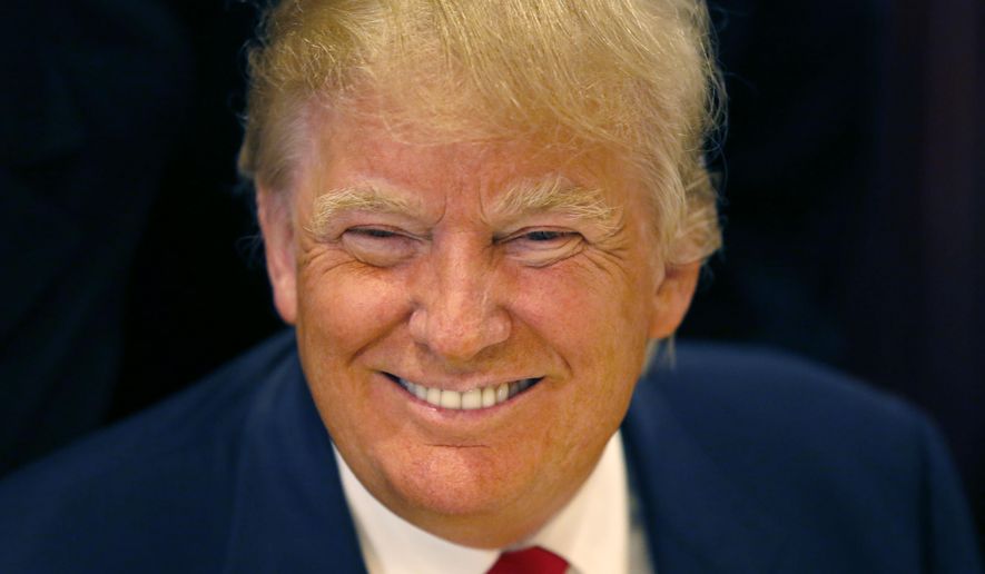 In this June 29, 2015, file photo, Republican presidential candidate Donald Trump smiles for a photographer before he addresses members of the City Club of Chicago, in Chicago. (AP Photo/Charles Rex Arbogast, File)