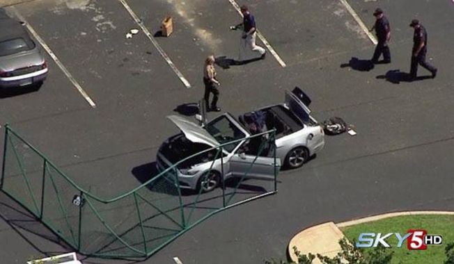In this aerial image taken from video, law enforcement personnel work the scene of a shooting at the Navy Operational Support Center and Marine Corps Reserve Center Chattanooga Thursday, July 17, 2015, in Chattanooga, Tenn. Authorities say Kuwait-born Muhammad Youssef Abdulazeez, 24, of Hixson, Tenn., unleashed a barrage of gun fire from his car at a recruiting center and the U.S. military site, killing at least four Marines before he was shot to death by police. (WTVF via AP) MANDATORY CREDIT, NO SALES