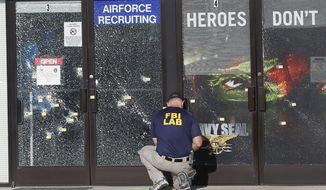 An FBI investigator investigates the scene of a shooting outside a military recruiting center on Friday, July 17, 2015, in Chattanooga, Tenn. Muhammad Youssef Abdulazeez of Hixson, Tenn.,  attacked two military facilities on Thursday, in a shooting rampage that killed four Marines. (AP Photo/John Bazemore) **FILE**