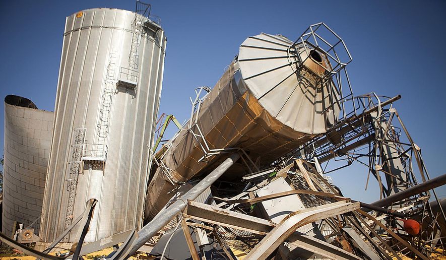 The twisted wreckage of several grain bins lie in a heap Friday July 17, 2015 in Cameron, Ill., the morning after a tornado swept through the city. At least three tornadoes hit communities in the northwest corner of Illinois and the central part of the state late Thursday, causing extensive damage but no significant injuries, officials said. (Steve Davis/The Register-Mail via AP)