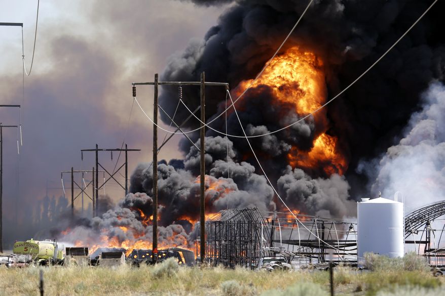 Smoke and flames rise above a fire burning several buildings at the Inland Trap & Liner company Friday, July 17, 2015, in Moses Lake, Wash. Grant County Sheriff's spokesman Kyle Foreman said no one was injured, but the fire has caused one propane tank to explode, sending a mushroom cloud 1,000 feet into the air. Numerous haystacks also burned. (AP Photo/Elaine Thompson)