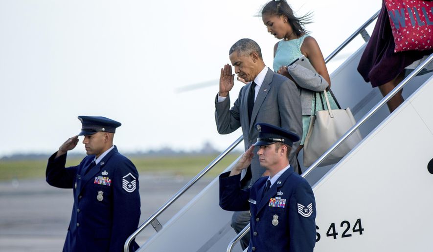 President Barack Obama, accompanied by Sasha Obama, right, departs Air Force One at JFK International Airport in New York, Friday, July 17, 2015. (AP Photo/Andrew Harnik)