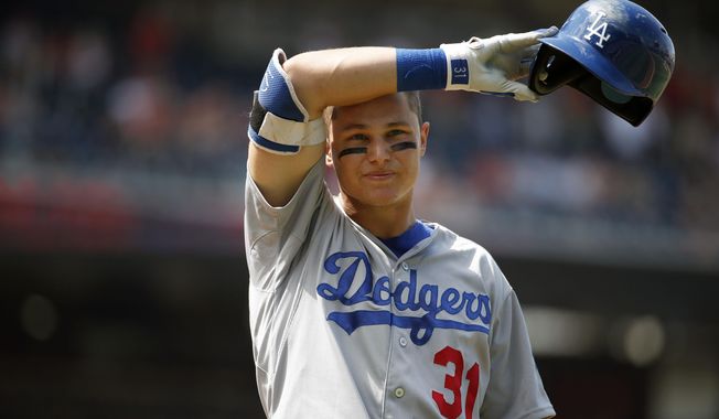 Los Angeles Dodgers center fielder Joc Pederson (31) wipes his brow during his at bat in the ninth inning of a resumed baseball game against the Washington Nationals at Nationals Park, Saturday, July 18, 2015, in Washington. The game was resumed in the top of the sixth inning after it was suspended July 17 due to a problem with the lights.  The Nationals won 5-3. (AP Photo/Alex Brandon)