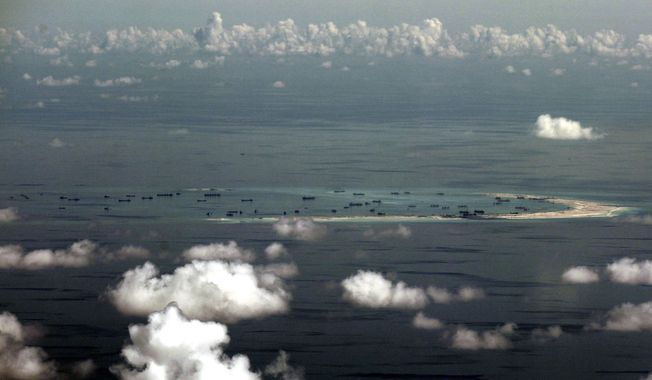 China&#x27;s alleged on-going reclamation of Mischief Reef in the Spratly Islands in the South China Sea.  (Ritchie B. Tongo/Pool Photo via AP) **FILE**