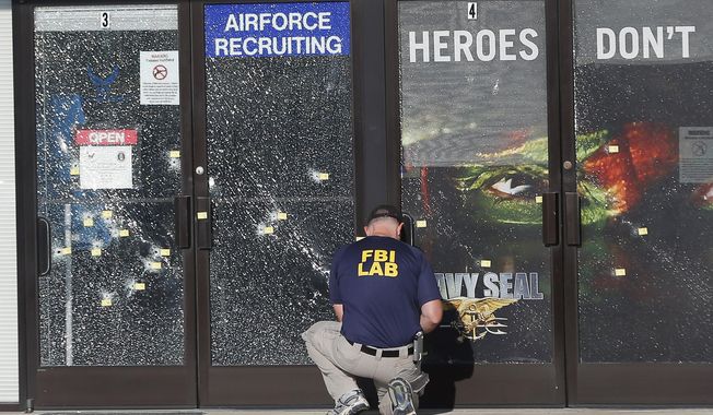 An FBI investigator investigates the scene of a shooting outside a military recruiting center in Chattanooga, Tennessee, on July 17, 2015. (Associated Press) **FILE**
