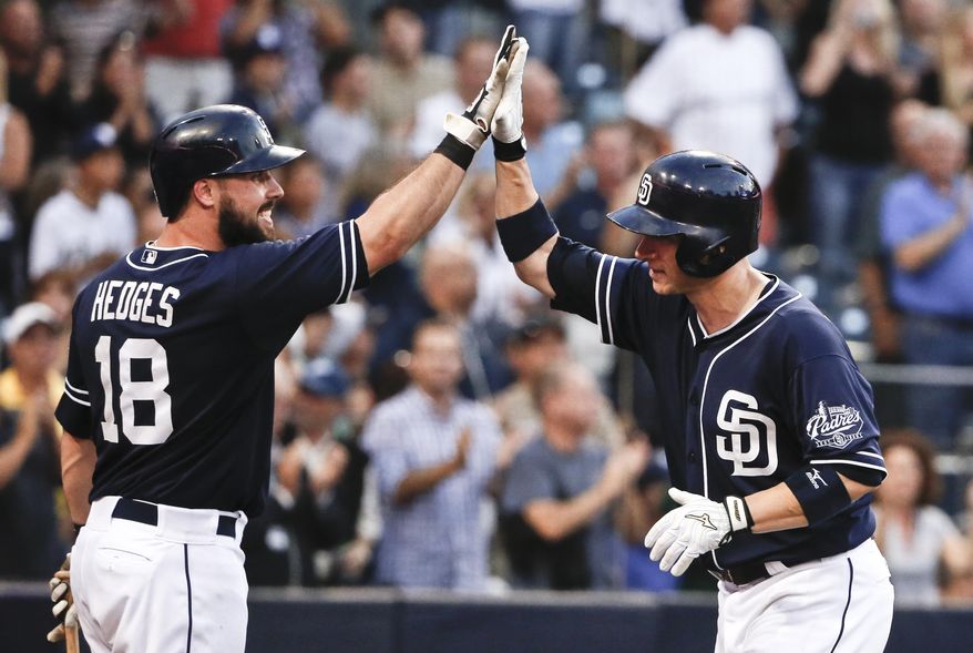 San Diego Padres' Clint Barmes, right, is congratulated by Austin Hedges after his two-run home run against the Colorado Rockies during the seventh inning of a baseball game Saturday, July 18, 2015, in San Diego. (AP Photo/Lenny Ignelzi)