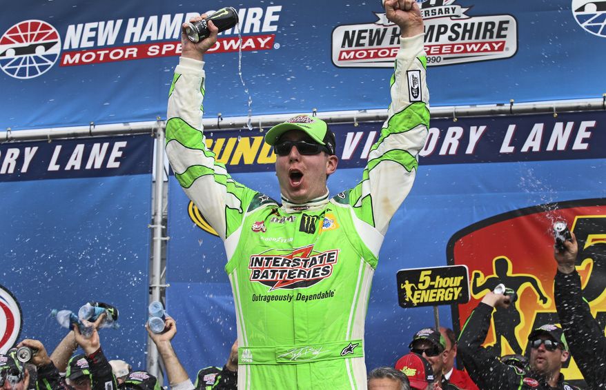 Kyle Busch celebrates in Victory Lane after winning the NASCAR Sprint Cup series auto race at New Hampshire Motor Speedway in Loudon, N.H., Sunday, July 19, 2015. (AP Photo/Cheryl Senter)