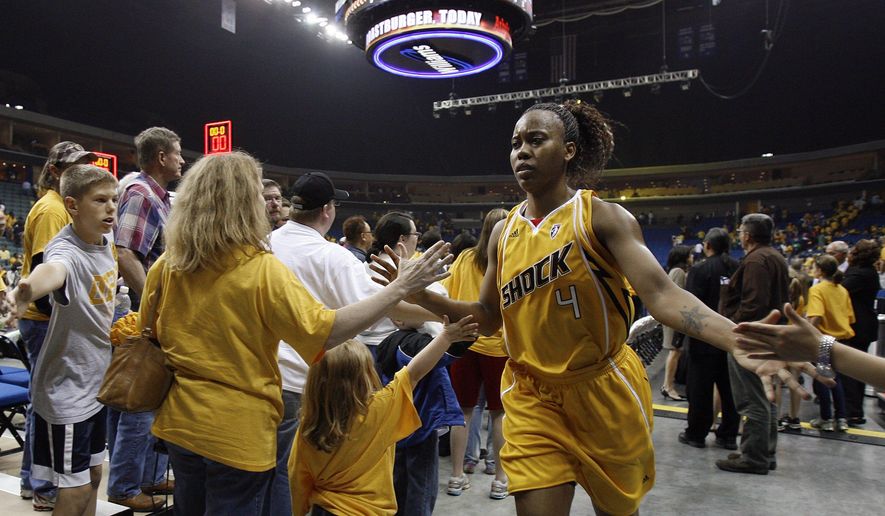 In this May 15, 2010, photo, fans high-five Tulsa Shock&#39;s Amber Holt after the Shock lost their inaugural game to the Minnesota Lynx in Tulsa, Okla. Tulsa Shock majority owner Bill Cameron announced plans Monday, July 20, 2015,  to move the WNBA franchise to the Dallas-Fort Worth market. (Stephen Holman/Tulsa World via AP) ONLINE OUT; KOTV OUT; KJRH OUT; KTUL OUT; KOKI OUT; KQCW OUT; KDOR OUT; TULSA OUT; TULSA ONLINE OUT