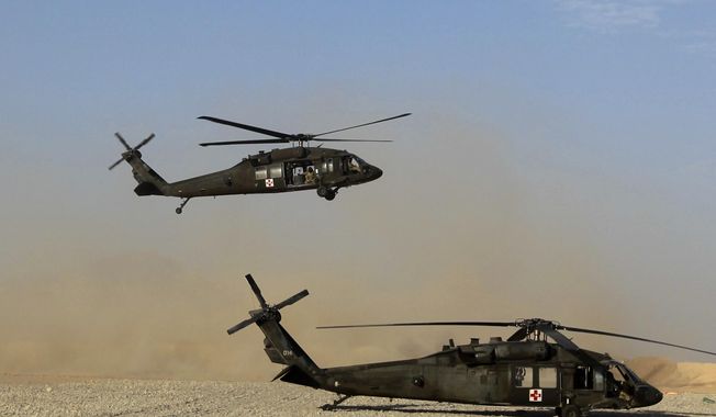 In this Sunday, Sept. 4, 2011, file photo, a Black Hawk helicopter of the U.S. Army&#x27;s Task Force Lift &amp; &quot;Dust Off,&quot; Charlie Company 1-71 Aviation Regiment, returns from a mission at Forward Operating Base Edi in the Helmand Province of southern Afghanistan. (AP Photo/Rafiq Maqbool, File) ** FILE **