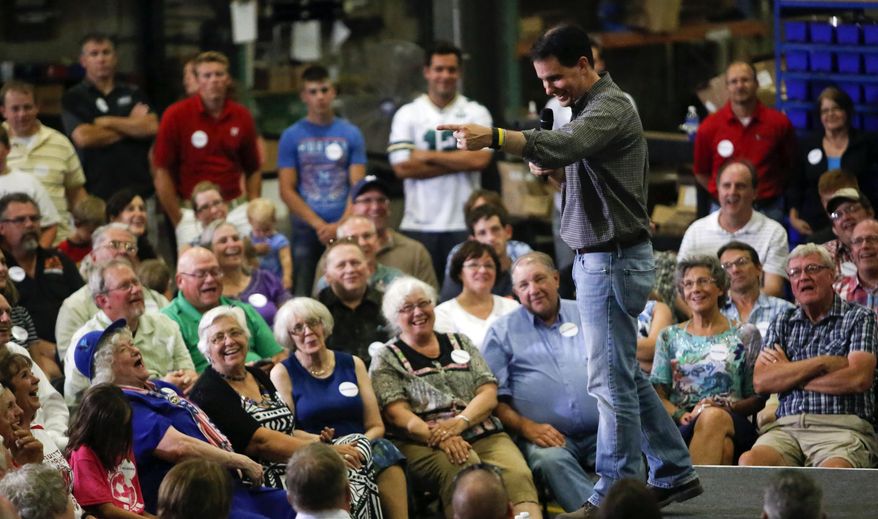 Republican presidential candidate Wisconsin Gov. Scott Walker addresses a crowd at Giese Manufacturing, Sunday, July 19, 2015, in Dubuque, Iowa. (Mike Burley/Telegraph Herald via AP)