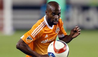 FILE - In this March 7, 2015, file photo, Houston Dynamo defender DaMarcus Beasley controls the ball during an MLS soccer match in Houston. Beasley was content with his December decision to retire from the U.S. national team. wanting to spend time with his now 16-month-old daughter. But when coach Jurgen Klinsmann asked him to return for the CONCACAF Gold Cup, the 33-year-old defender could not say no.  (AP Photo/Bob Levey, File)