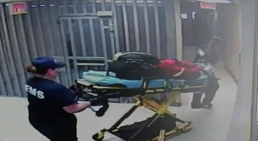 In this July 13, 2015, frame taken from video provided by the Waller County Sheriff's Department from a motion-operated camera, emergency personnel carry a gurney near Sandra Bland's jail cell, at the Waller County jail in Hempstead, Texas. The video, released Monday, July 20, shows there was no activity for about 90 minutes in the hallway leading to the cell where authorities say Bland was found hanged, three days after her arrest. (Waller County Sheriff's Department via AP)