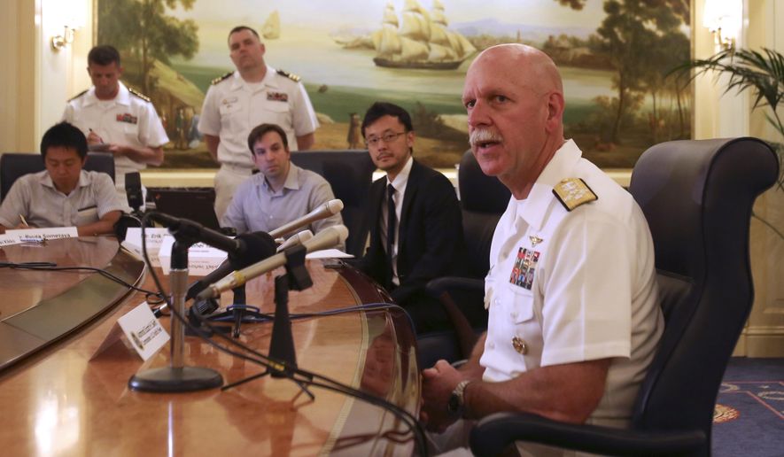 Adm. Scott Swift, right, the new commander of the U.S. Pacific Fleet, speaks during a press conference in Tokyo Tuesday, July 21, 2015 during the last stop of a three-country Asian tour. The commander sounded a conciliatory note toward China. &quot;We have much more in common than we do in competition,&quot; Swift told reporters. He added, though, that the Navy is ready to respond to any situation that might arise, if called upon by the American president. (AP Photo/Ken Moritsugu)