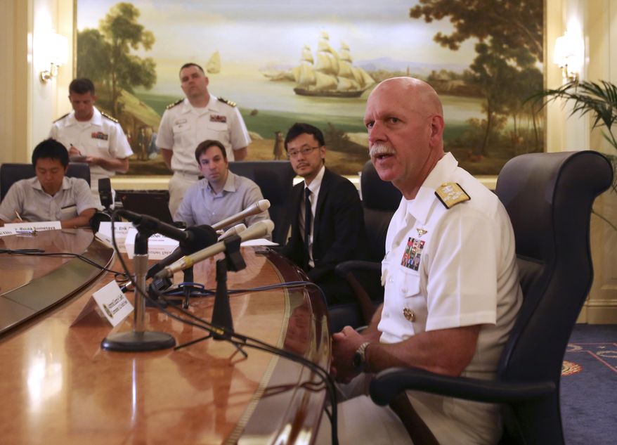 Adm. Scott Swift, right, the new commander of the U.S. Pacific Fleet, speaks during a press conference in Tokyo Tuesday, July 21, 2015 during the last stop of a three-country Asian tour. The commander sounded a conciliatory note toward China. "We have much more in common than we do in competition," Swift told reporters. He added, though, that the Navy is ready to respond to any situation that might arise, if called upon by the American president. (AP Photo/Ken Moritsugu)