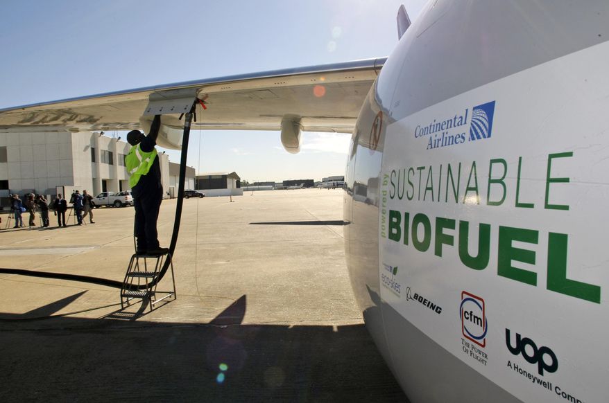 In this Jan. 7, 2009, file photo, Monte Hawkins prepares to remove the fuel line attached to a Continental Airlines jet for the first biofuel-powered demonstration flight of a U.S. commercial airliner, at Bush Intercontinental Airport in Houston. Many in the industry believe that without a replacement for jet fuel, growth in air travel could be threatened by forthcoming rules that limit global aircraft emissions. (AP Photo/David J. Phillip, File)
